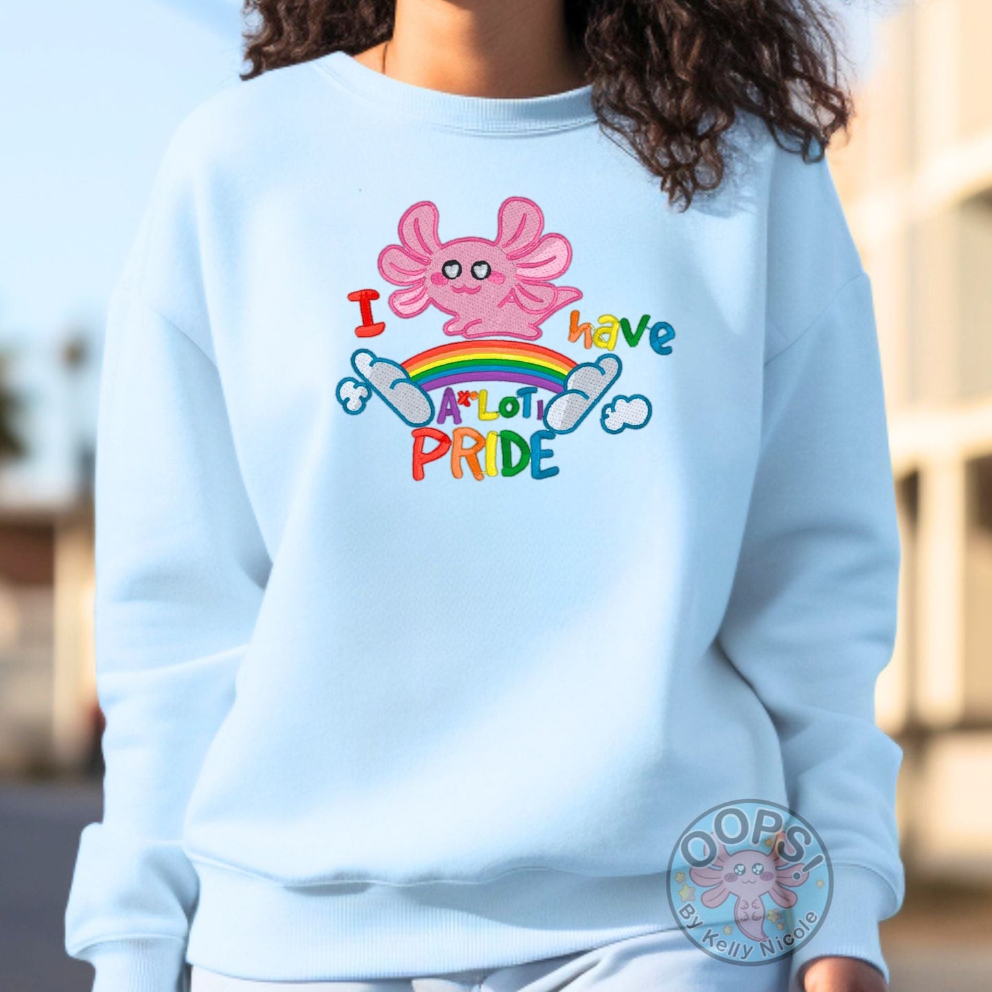 Embroidered "Axolotl PRIDE" Rainbow LGBTQIA+ Unisex Custom Sweatshirt in Blue. Order yours today at https://oopsbykellynicole.com.