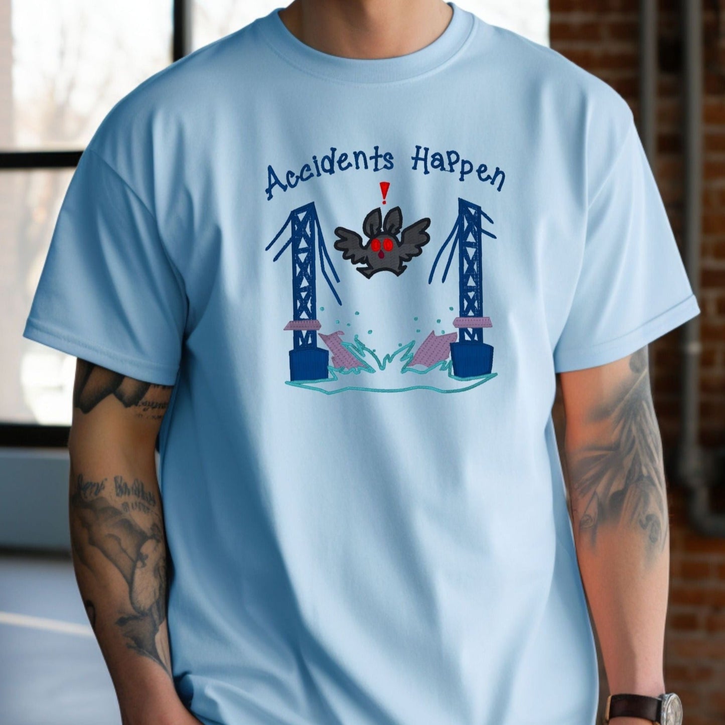 Mothman "Accidents Happen" Funny" Embroidered Heavyweight Unisex Comfort Colors T-shirt iN BLUE Shop online today to get yours at HTTPS://OOPSBYKELLYNICOLE.COM 