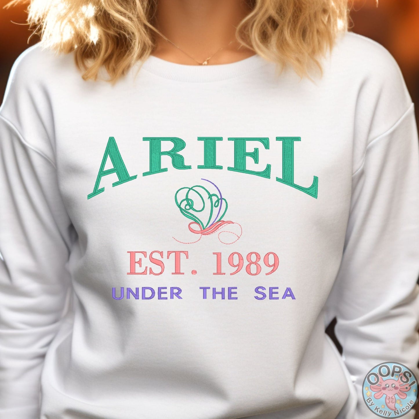 “ARIEL”  Disney Princess  Embroidered  Heavyweight Unisex Sweatshirt in WHITE.  Shop online today to get yours at HTTPS://OOPSBYKELLYNICOLE.COM