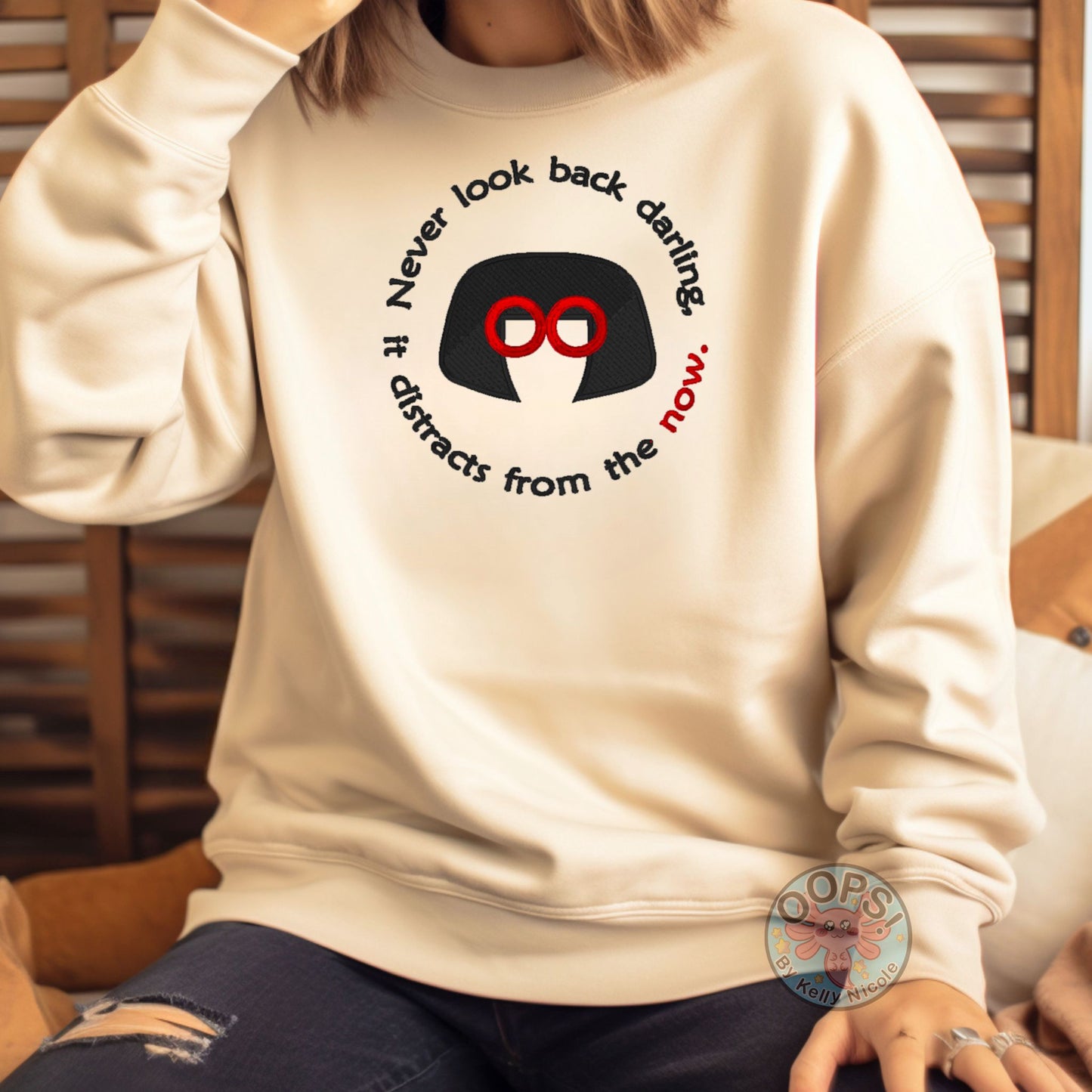 Embroidered "Never look back darling, it distracts from the Now" Edna-inspired Sweatshirt in Sand. Order yours today at https://oopsbykellynicole.com.