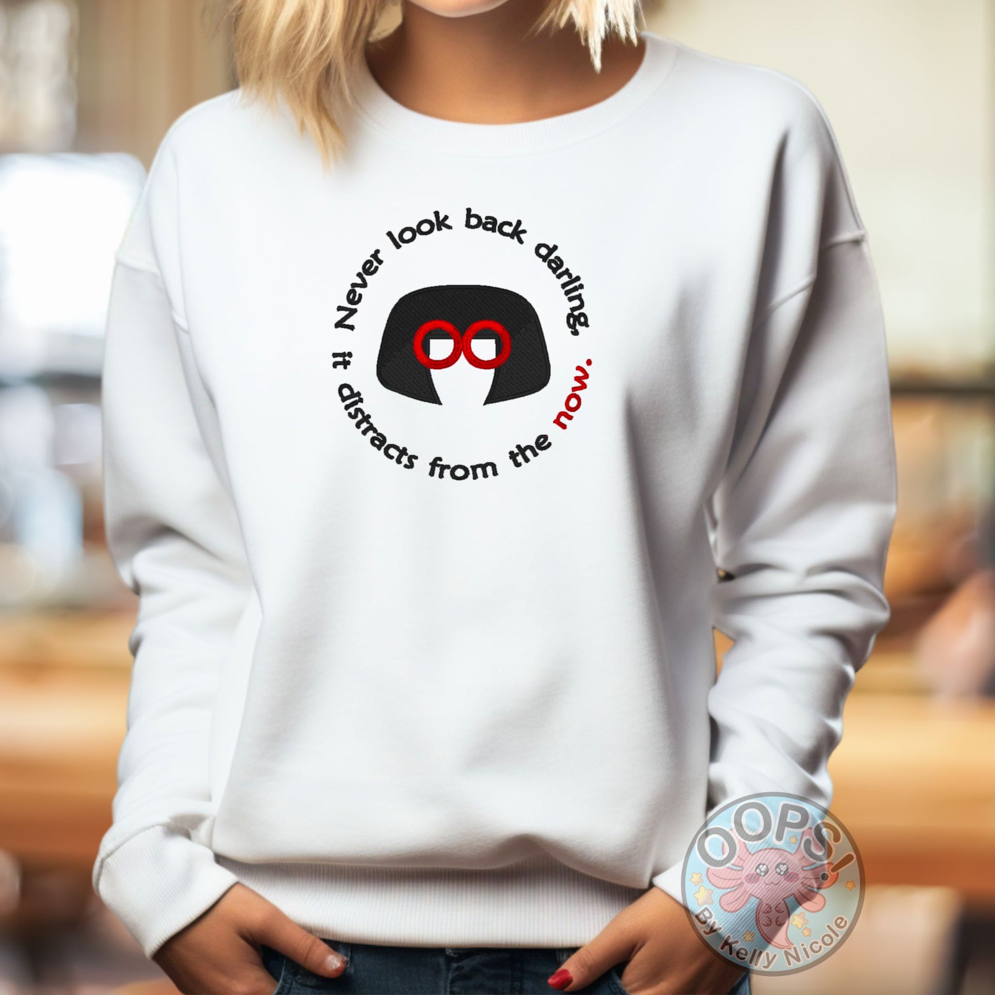 Embroidered "Never look back darling, it distracts from the Now" Edna-inspired Sweatshirt in White. Order yours today at https://oopsbykellynicole.com.