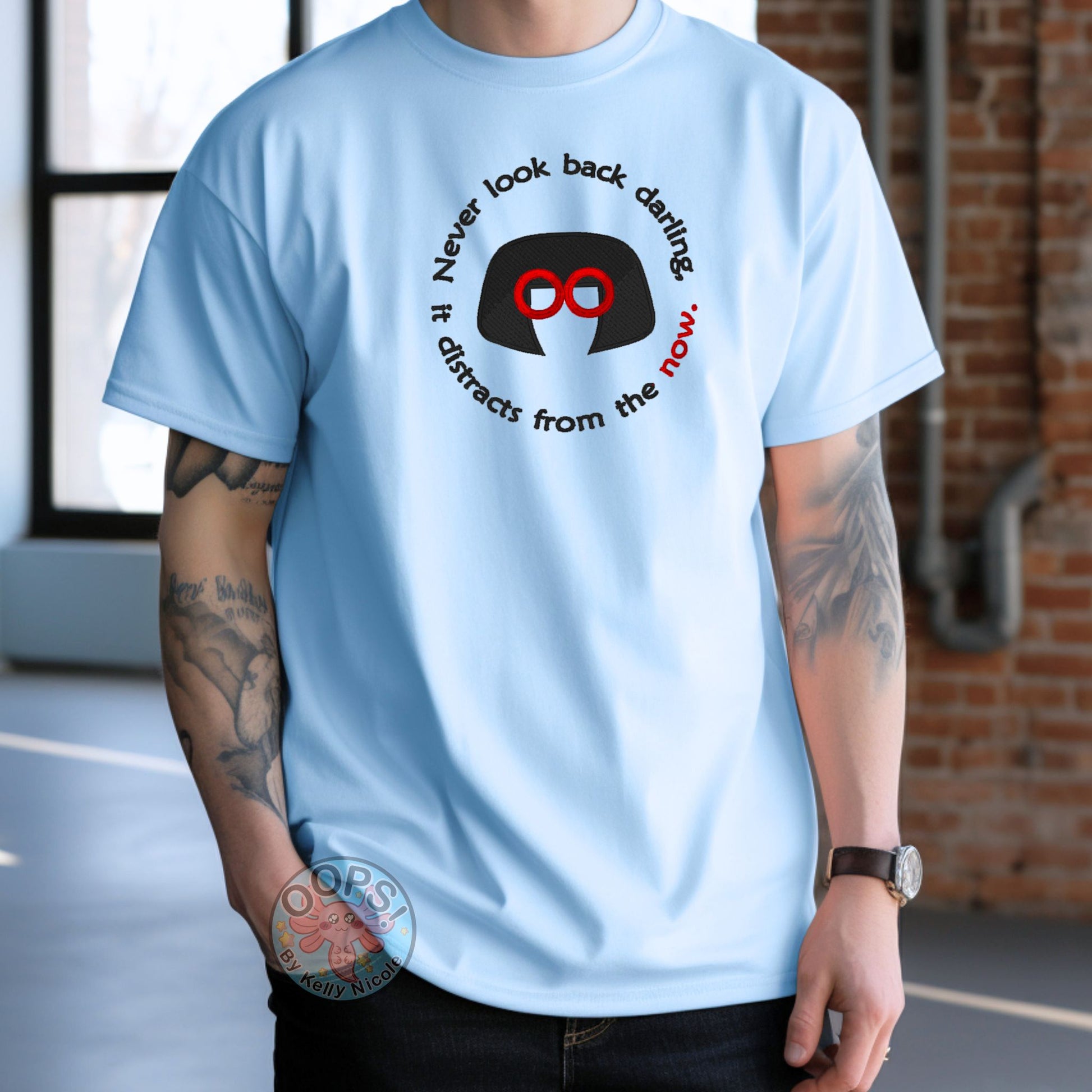 Embroidered "Never look back darling, it distracts from the Now" Edna-inspired Unisex T-shirt in Blue. Order yours today at https://oopsbykellynicole.com.