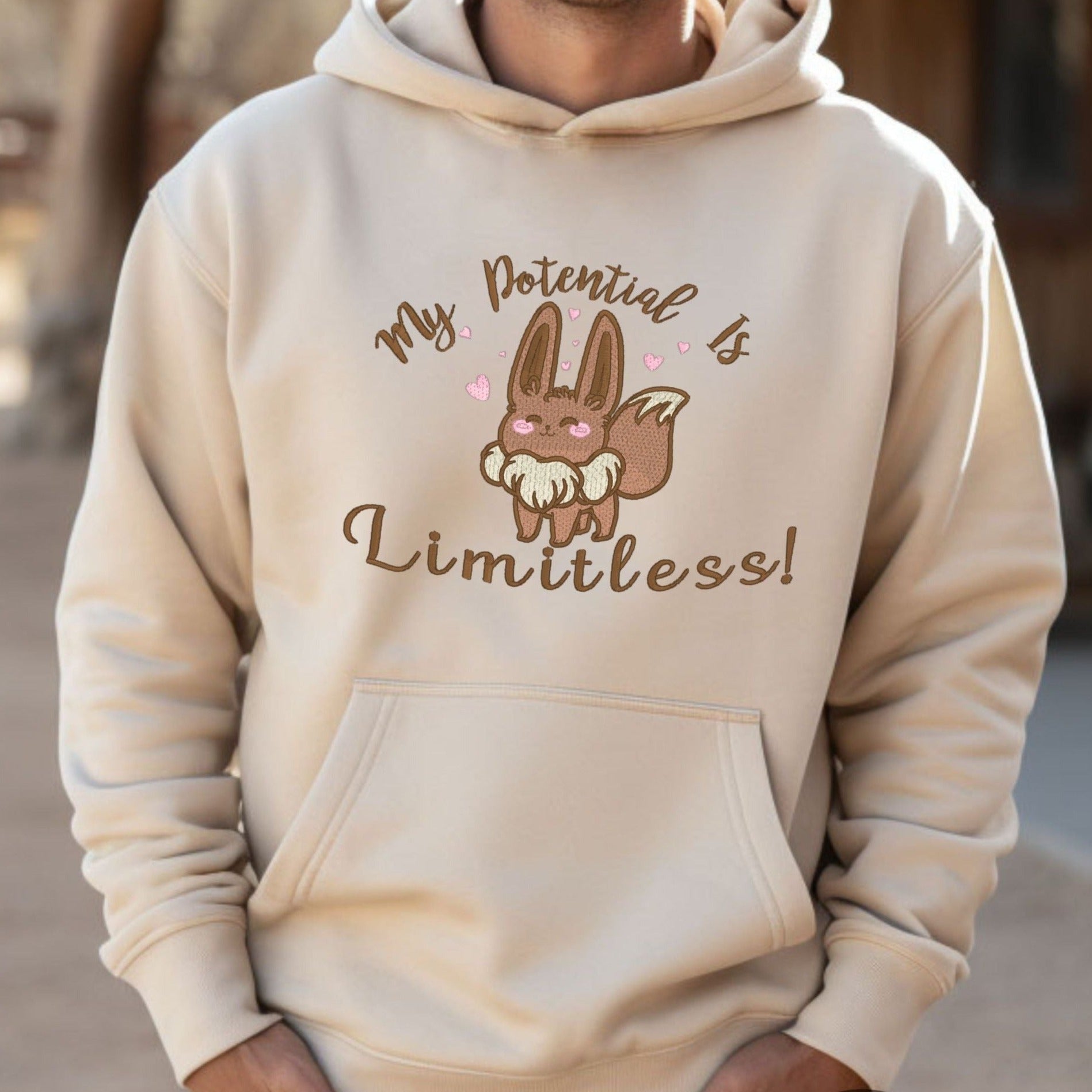  Pokemon Go Eevee-lution Shirt.  “My Potential is Limited” Embroidered Evee Heavyweight Unisex Hoodie in Sand. Order yours today at oopsbykellynicole.com