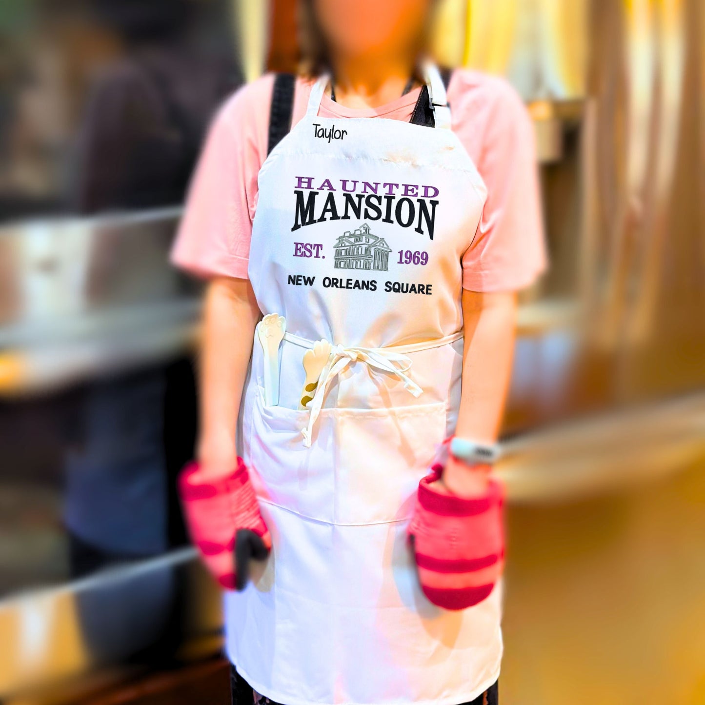 The perfect personalized Disney Haunted Mansion-lover gift for that person who has everything!&nbsp; Our Unisex Bib-Apron is 100% polyester, stain resistant machine washable fabric.&nbsp; It is fully adjustable with two convenient front pockets for all your essentials.  Order yours today at HTTPS://OOPSBYKELLYNICOLE.COM