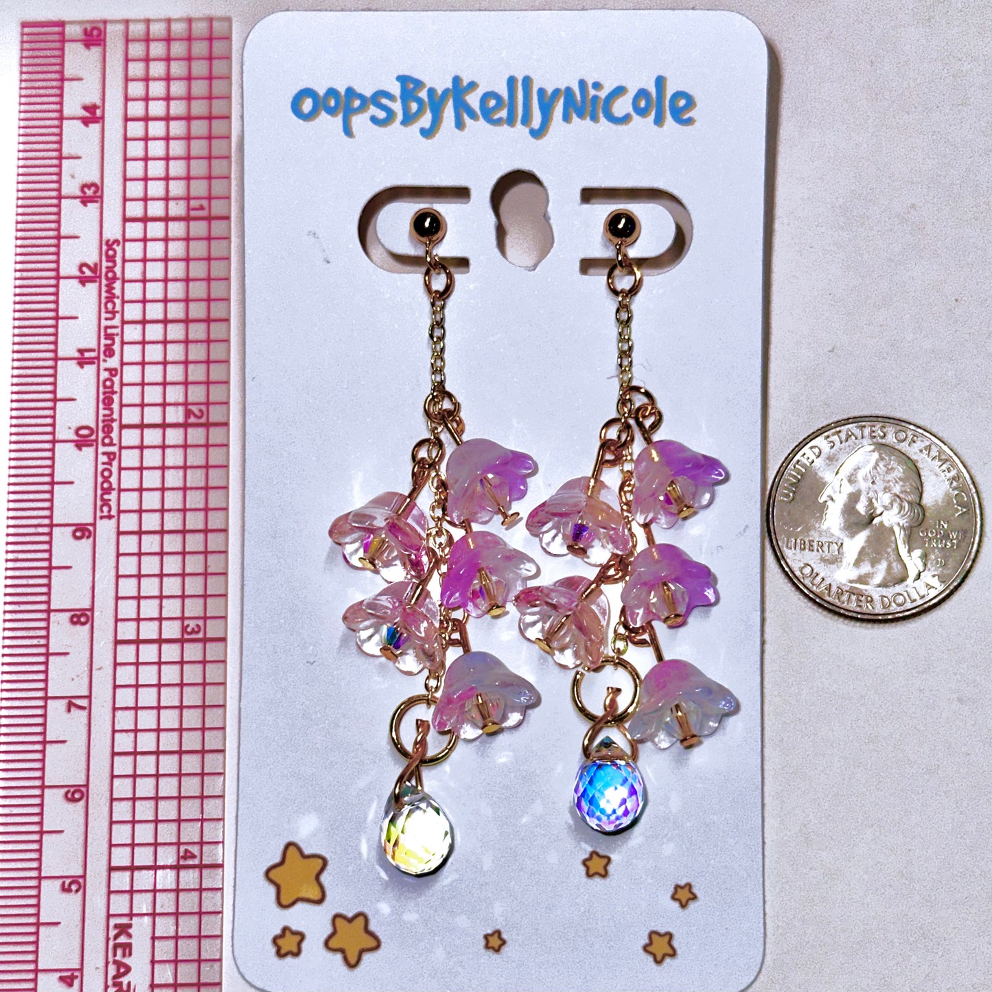 Wisteria  Blush  Pink Floral Drop Earrings with Crystal dangle. Gold or Silver- Plated.  Lightweight, Hypoallergenic Statement posts. Its  seamlessly transitions from casual outings, Weddings and elegant events. Measurements  Shop online today to get yours at HTTPS://OOPSBYKELLYNICOLE.COM 