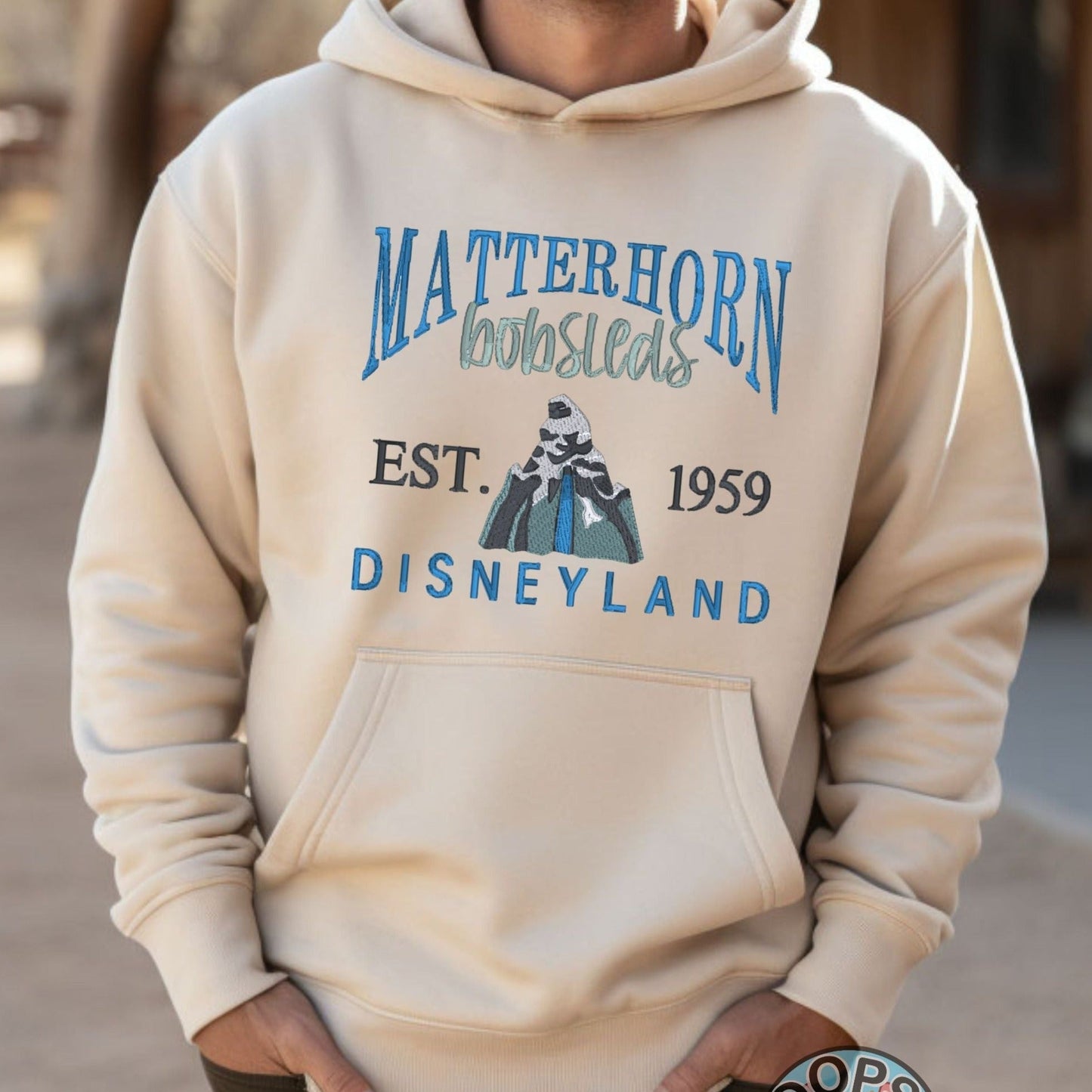 DISNEY “MATTERHORN” Theme Park Embroidered Heavyweight Unisex Hoodie in SAND.  Shop online today to get yours at HTTPS://OOPSBYKELLYNICOLE.COM 