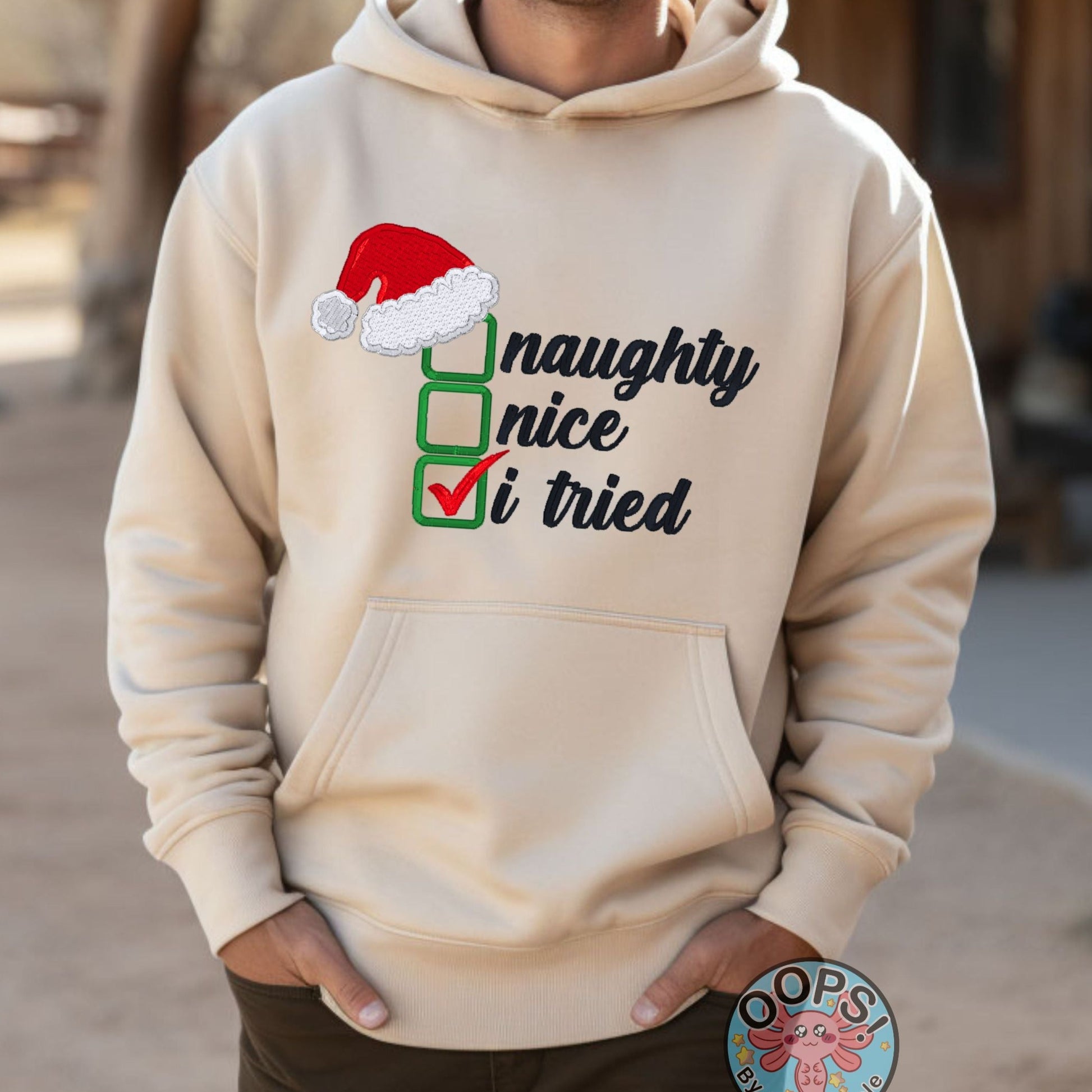 Christmas "Naughty or Nice" Humorous Holiday Embroidered Heavyweight Unisex Hoodie in SAND  Shop online today to get yours at HTTPS://OOPSBYKELLYNICOLE.COM 