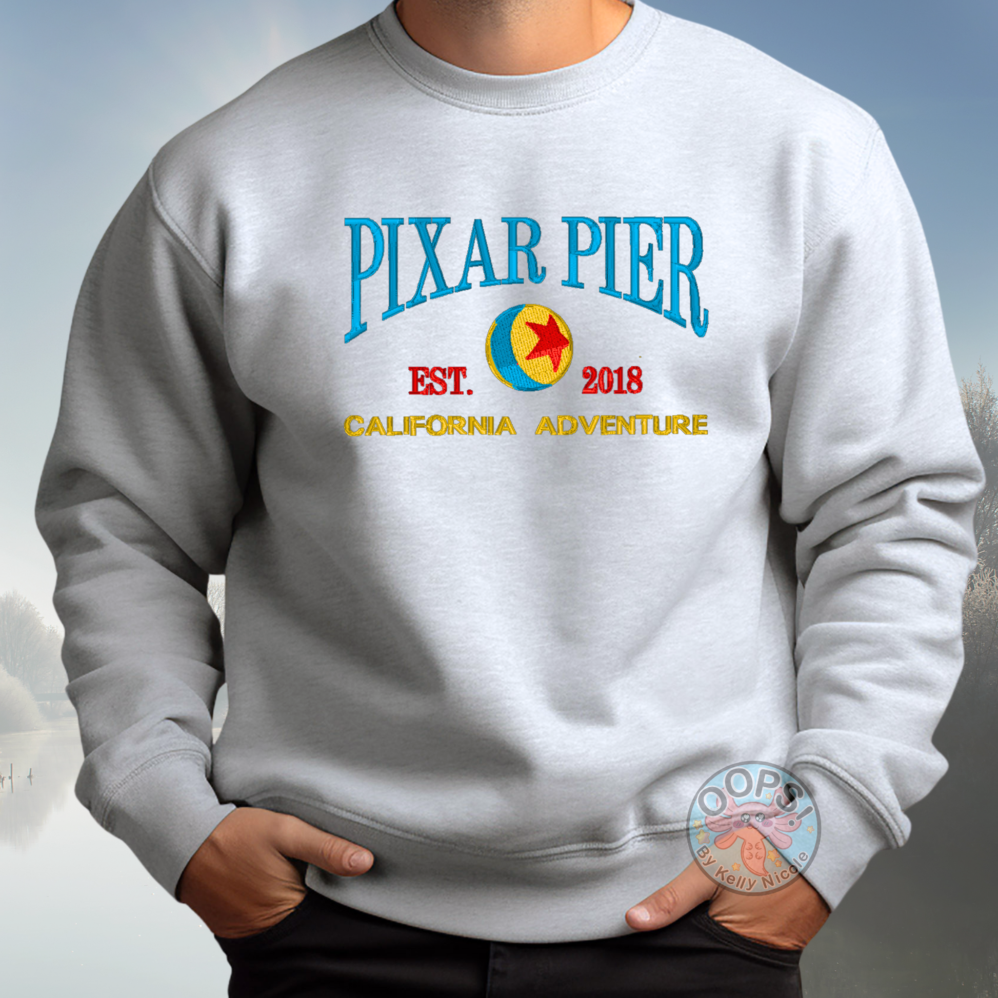 Embroidered Disney “Pixar Pier” DCA inspired  Unisex  Sweatshirt in Ash. Perfect for Home, work or anytime cozy comfort wear.  Order yours today at https://oopsbykellynicole.com.