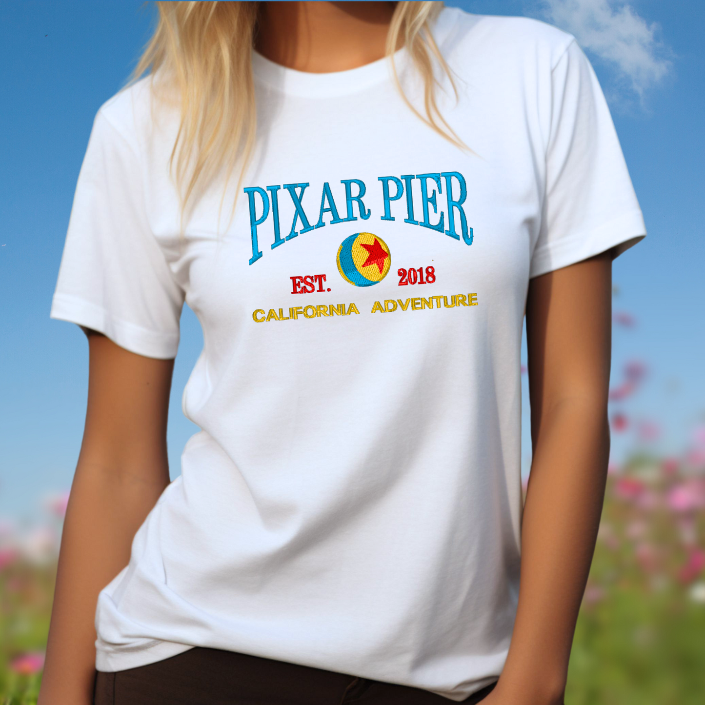 Embroidered Disney “Pixar Pier” DCA inspired  Unisex ComfortColors T-shirt in White. Perfect for Home, work or anytime cozy comfort wear.  Order yours today at https://oopsbykellynicole.com.