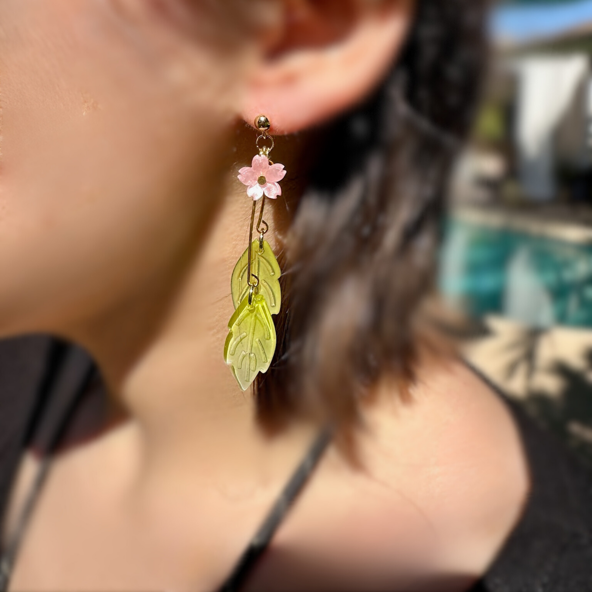 Sakura Pink Cherry Blossom earrings with elegant green with leaf Drops with choice of Silver or Gold-plated hypoallergenic posts. Lightweight and  perfect for home, work, party or memorable Gift. On model.Shop online today to get yours at HTTPS://OOPSBYKELLYNICOLE.COM