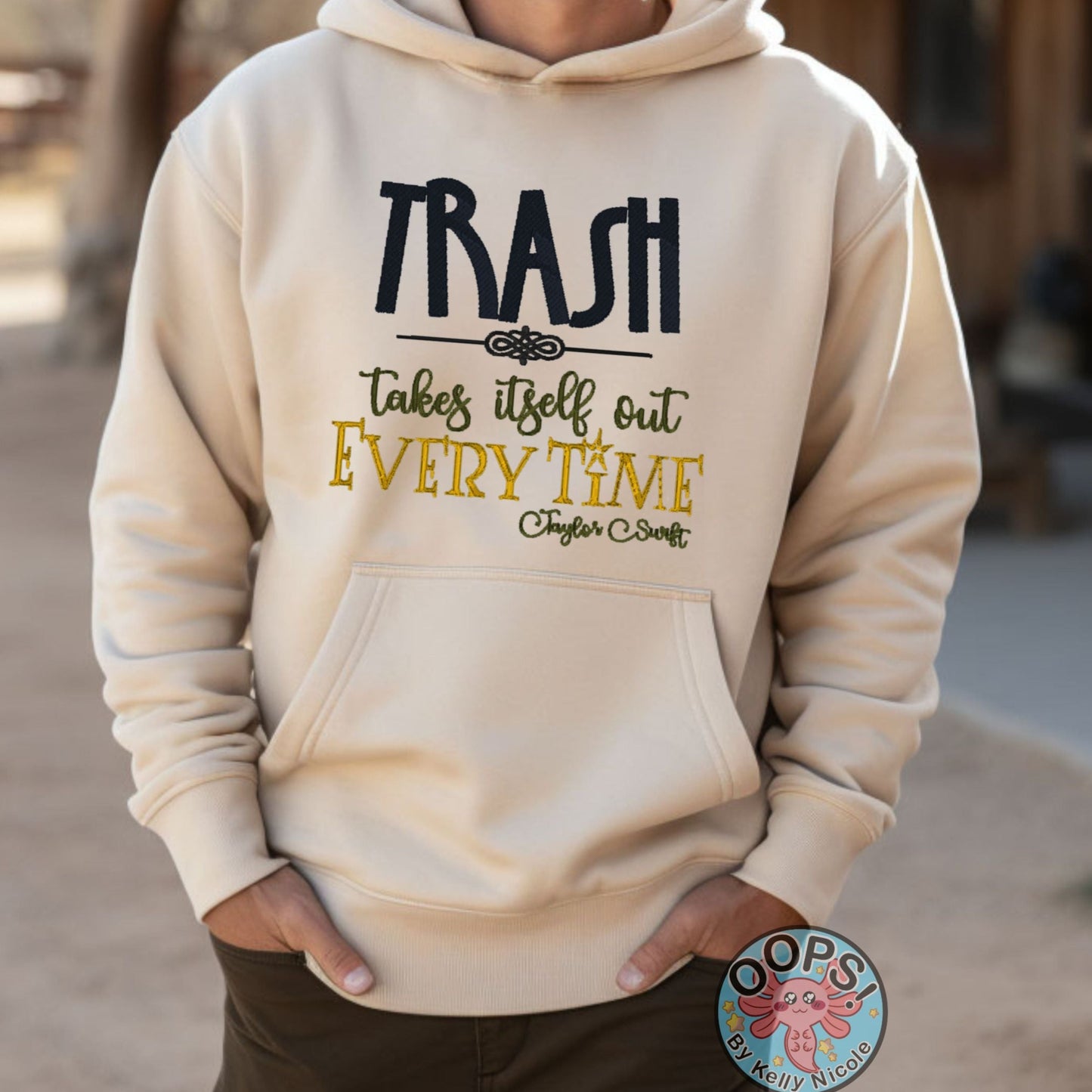 Taylor Swift “TRASH TAKES ITSELF OUT EVERY TIME“ Embroidered Fandom Embroidered Heavyweight Unisex Hoodie in SAND.  Shop online today to get yours at HTTPS://OOPSBYKELLYNICOLE.COM 