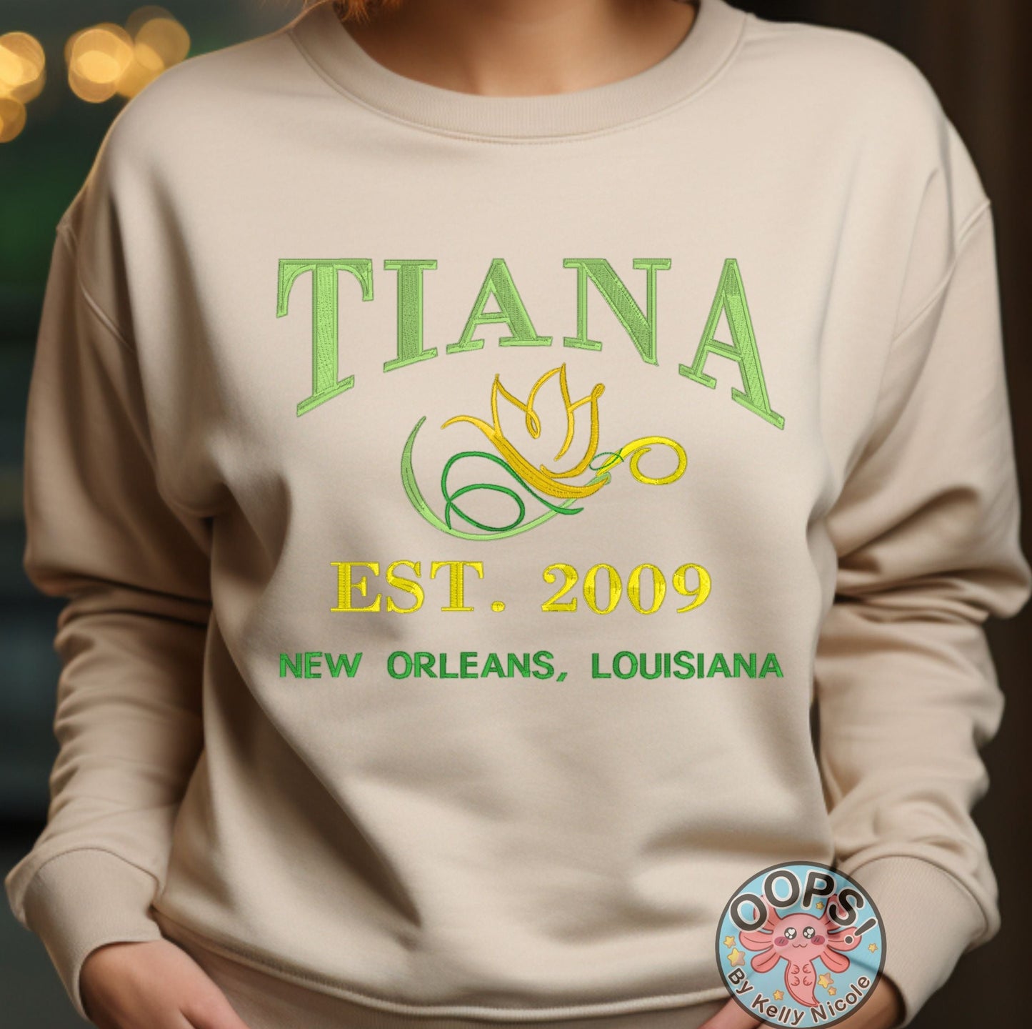 TIANA Disney Princess Embroidered  Heavyweight Unisex Sweatshirt in SAND.  Shop online today to get yours at HTTPS://OOPSBYKELLYNICOLE.COM 