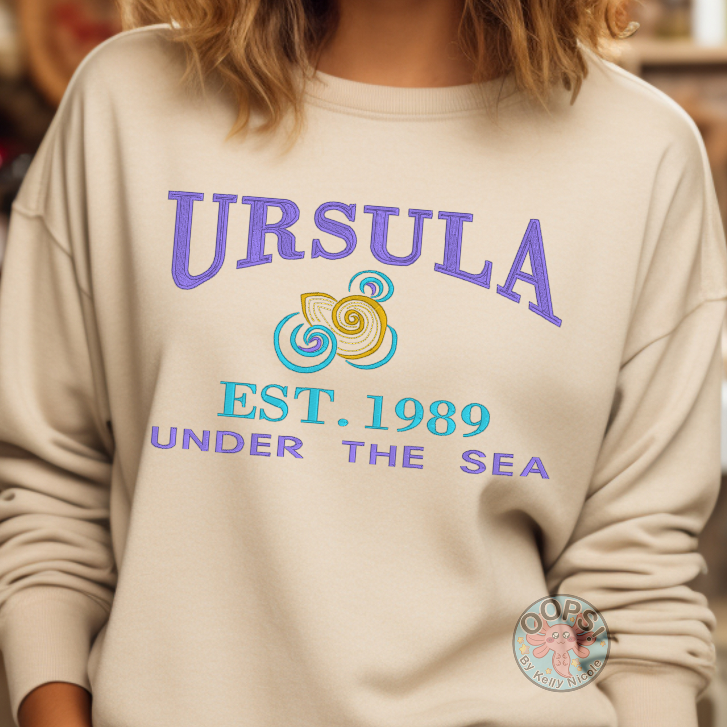 URSULA  Disney Villain Embroidered  Heavyweight Unisex Sweatshirt in SAND.  Shop online today to get yours at HTTPS://OOPSBYKELLYNICOLE.COM 