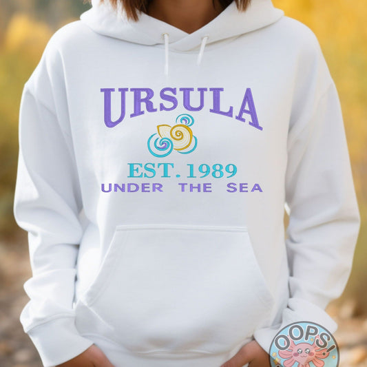 URSULA  Disney Villain Embroidered Heavyweight Unisex Hoodie in WHITE.  Shop online today to get yours at HTTPS://OOPSBYKELLYNICOLE.COM 