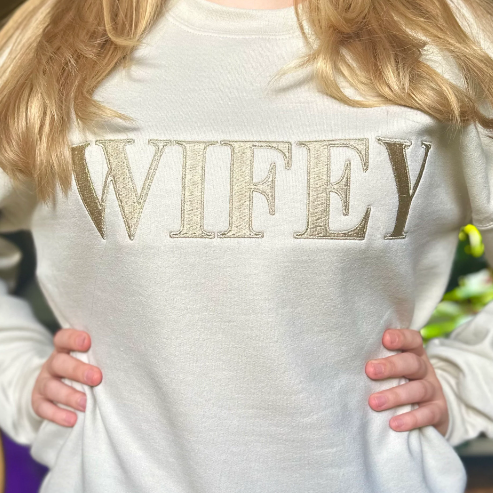 Embroidered "WIFEY" shirt, Wedding Shirt, Engagement shirt, Honeymoon shirt, Wedding shower Gift. Heavyweight Unisex Sweatshirt in Sand.  Shop online today to get yours at HTTPS://OOPSBYKELLYNICOLE.COM 