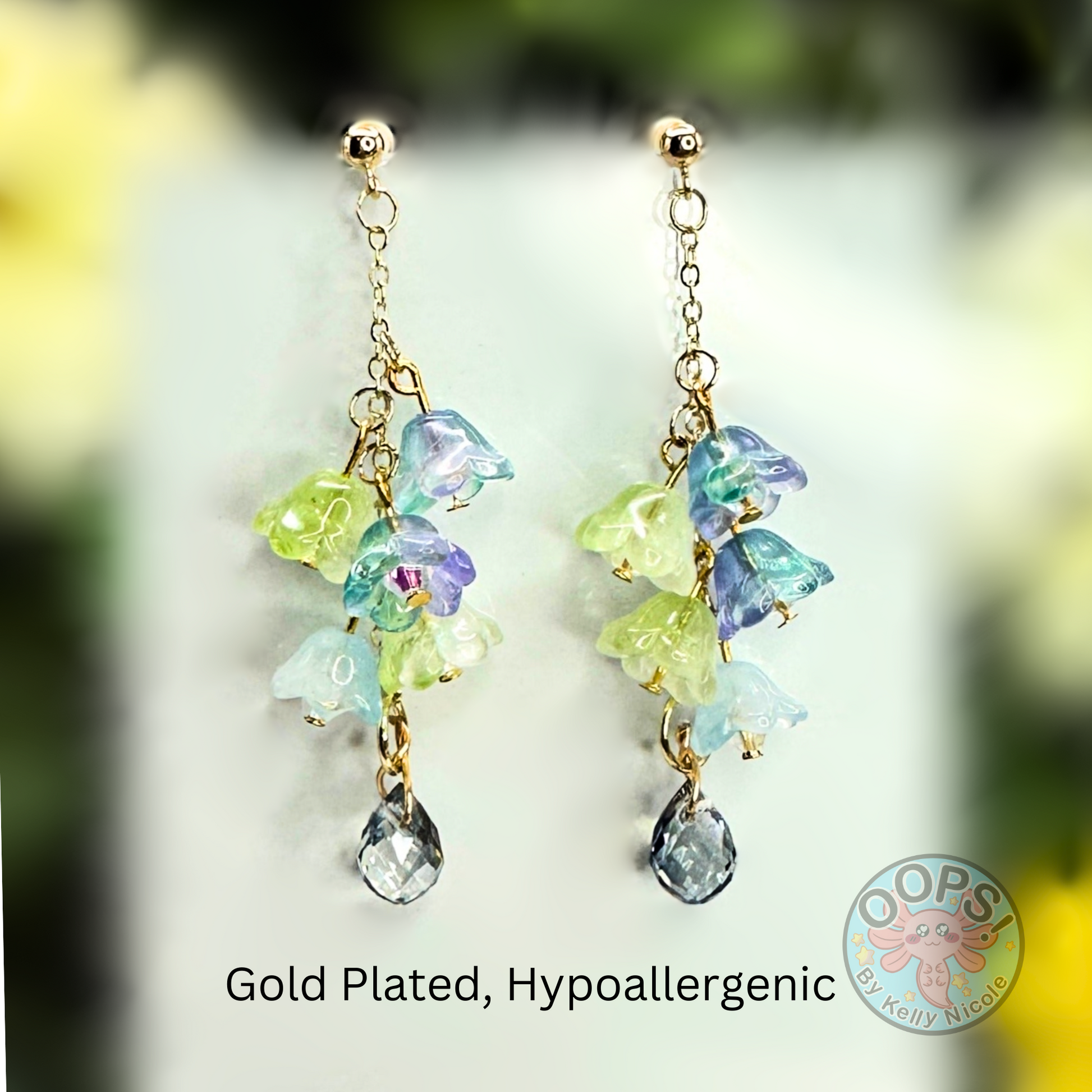 Wisteria Blue Green  Floral Drop Earrings with Crystal dangle. Gold - Plated.  Lightweight, Hypoallergenic Statement posts. Its  seamlessly transitions from casual outings, Weddings and elegant events. 004 Shop online today to get yours at HTTPS://OOPSBYKELLYNICOLE.COM 