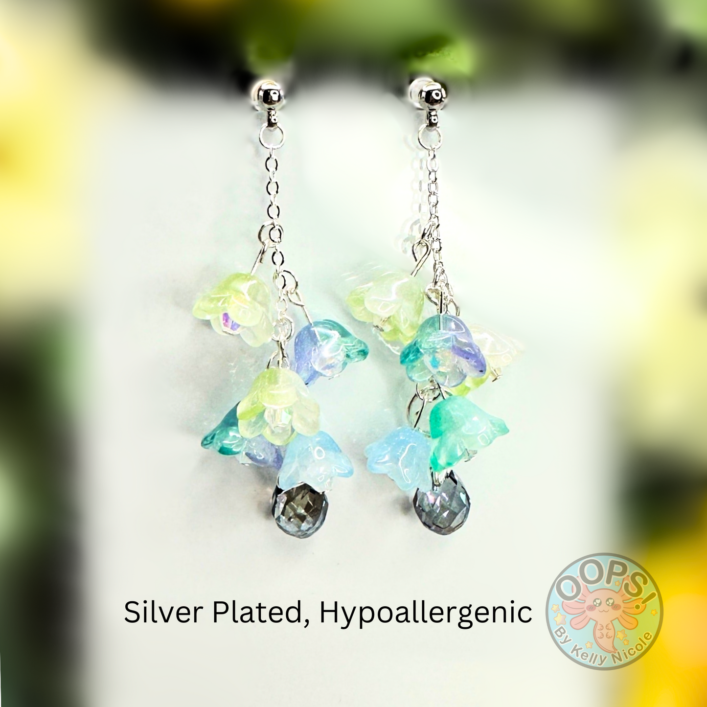 Wisteria Blue Green  Floral Drop Earrings with Crystal dangle.  Silver- Plated.  Lightweight, Hypoallergenic Statement posts. Its  seamlessly transitions from casual outings, Weddings and elegant events. 003 Shop online today to get yours at HTTPS://OOPSBYKELLYNICOLE.COM 